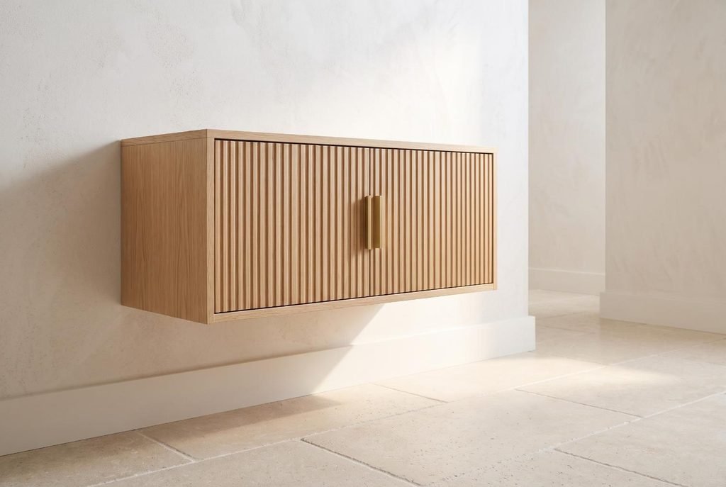 Modern wall-mounted floating wood storage cabinet suspended above bathroom floor tile.